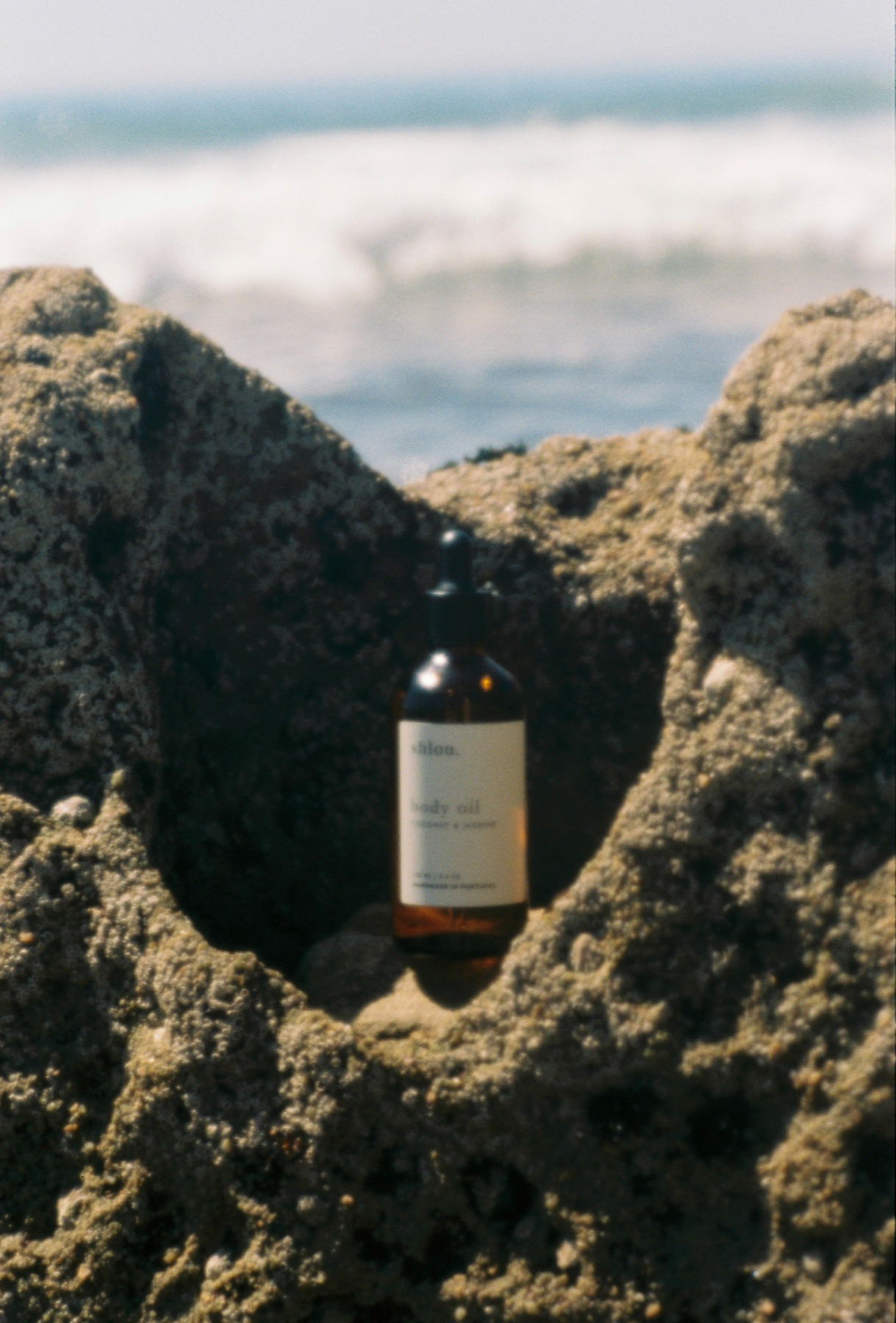 A shlou bottle resting in the coastal rocks